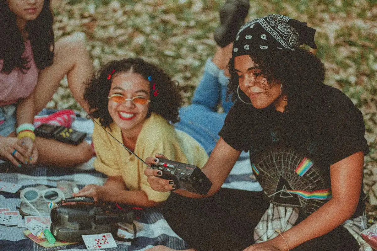 Two teens on the beach in a retro 1980s vibe