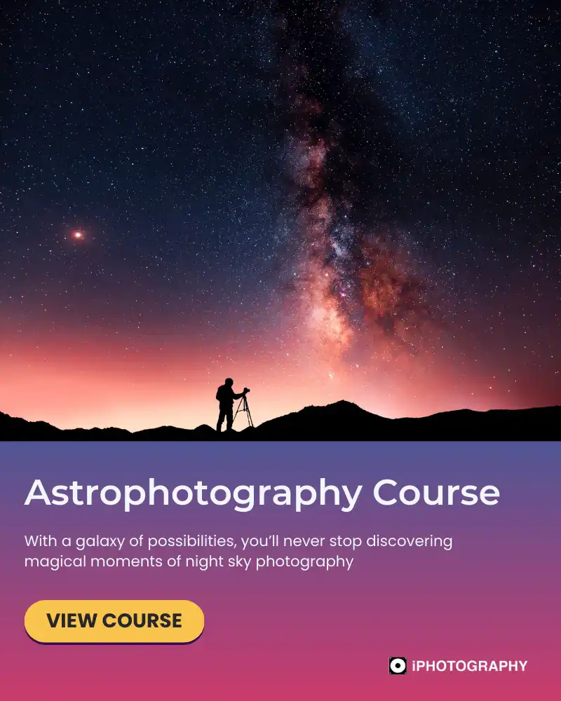 a silhouette of a person with a camera on a tripod taking photos of the night sky milky way