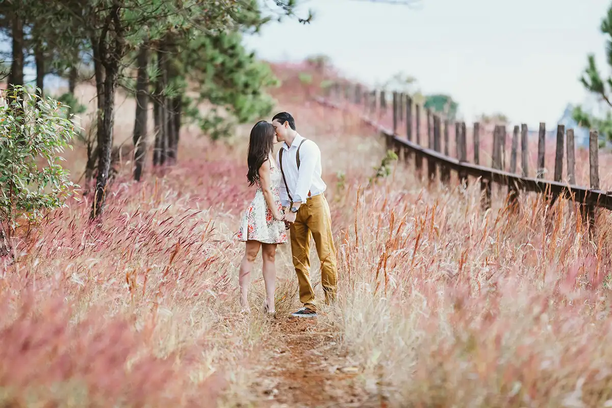 A couple kissing in a field