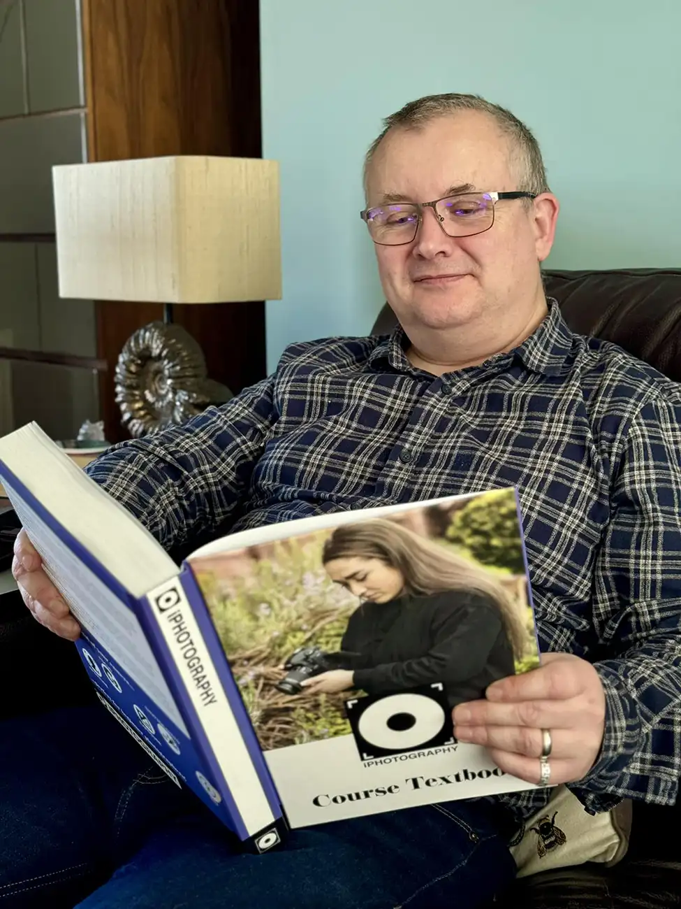 Photographer Grant Anthony reading the iPhotography Course textbook