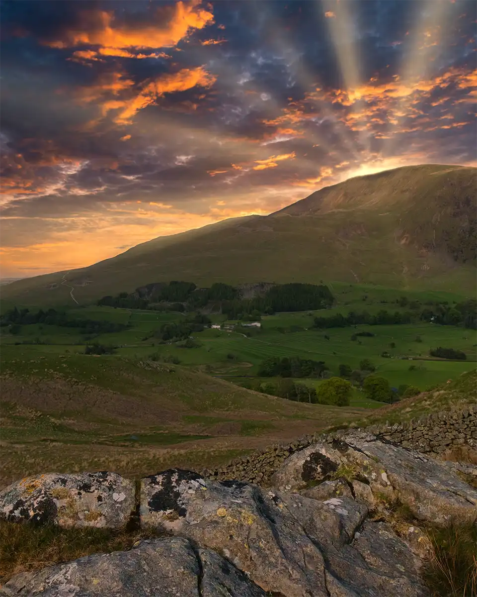 St Johns in the Vale in the UK's Lake District with the sun behind the hill